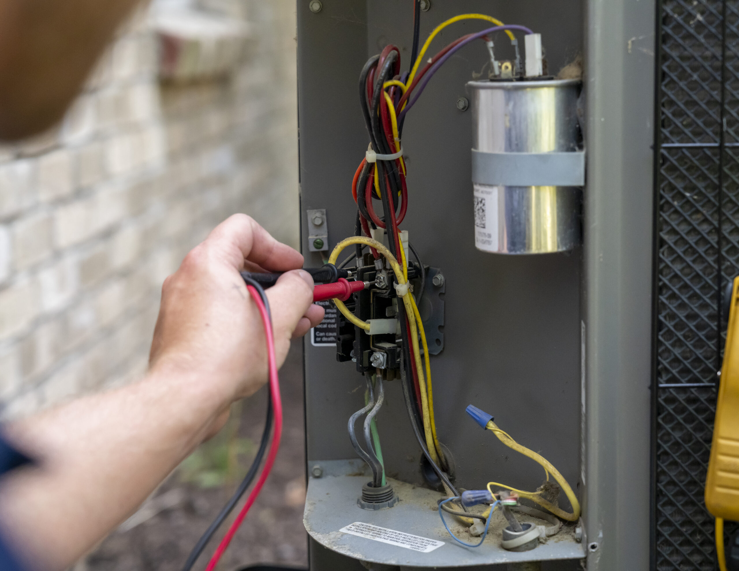Mandolin Services technician inspecting residential heating equipment during a repair visit